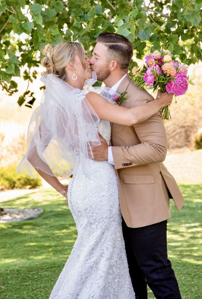Happy couple embracing on their wedding day, bride in an off-the-rack designer gown - Strictly Weddings Phoenix AZ