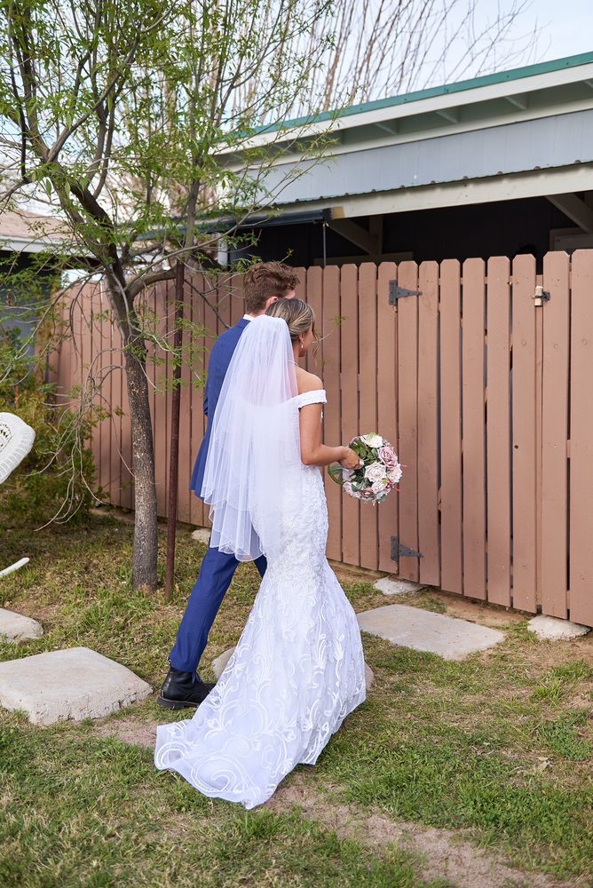 Bride in a fitted lace wedding dress with veil - Strictly Weddings Phoenix AZ