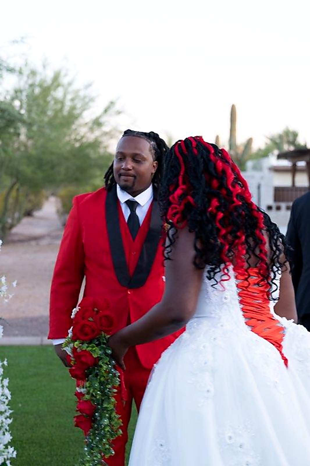 Red lace-up corset back and beaded bodice on a white off-the-rack designer ballgown wedding dress - Strictly Weddings Phoenix AZ
